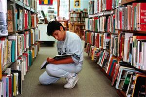 NEW JERSEY, TEANECK. BOY IN LIBRARY READING BOOK.. Photography. Encyclopædia Britannica ImageQuest. Web. 7 Aug 2014. 