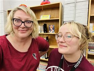 Ms. Moore and Ms. Curtsinger smile for camera