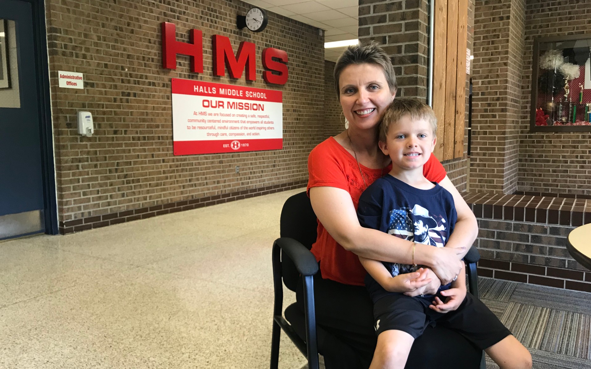 Karen Casteel, a music teacher at Halls Middle School, sits in the lobby with her son, Ethan. 