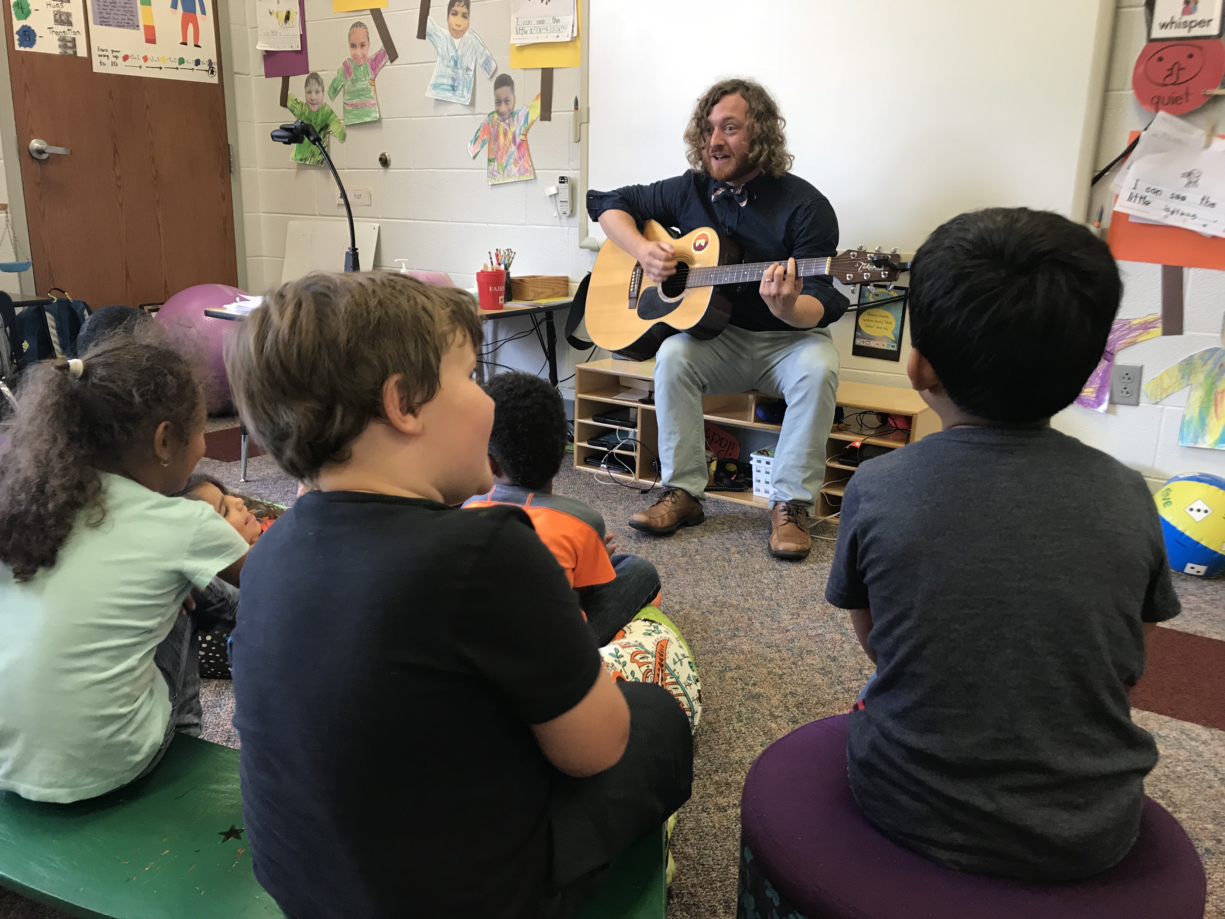 Christenberry Elementary teacher Michael 'Mac' Comer plays the guitar for his kindergarten class on Oct. 4, 2018