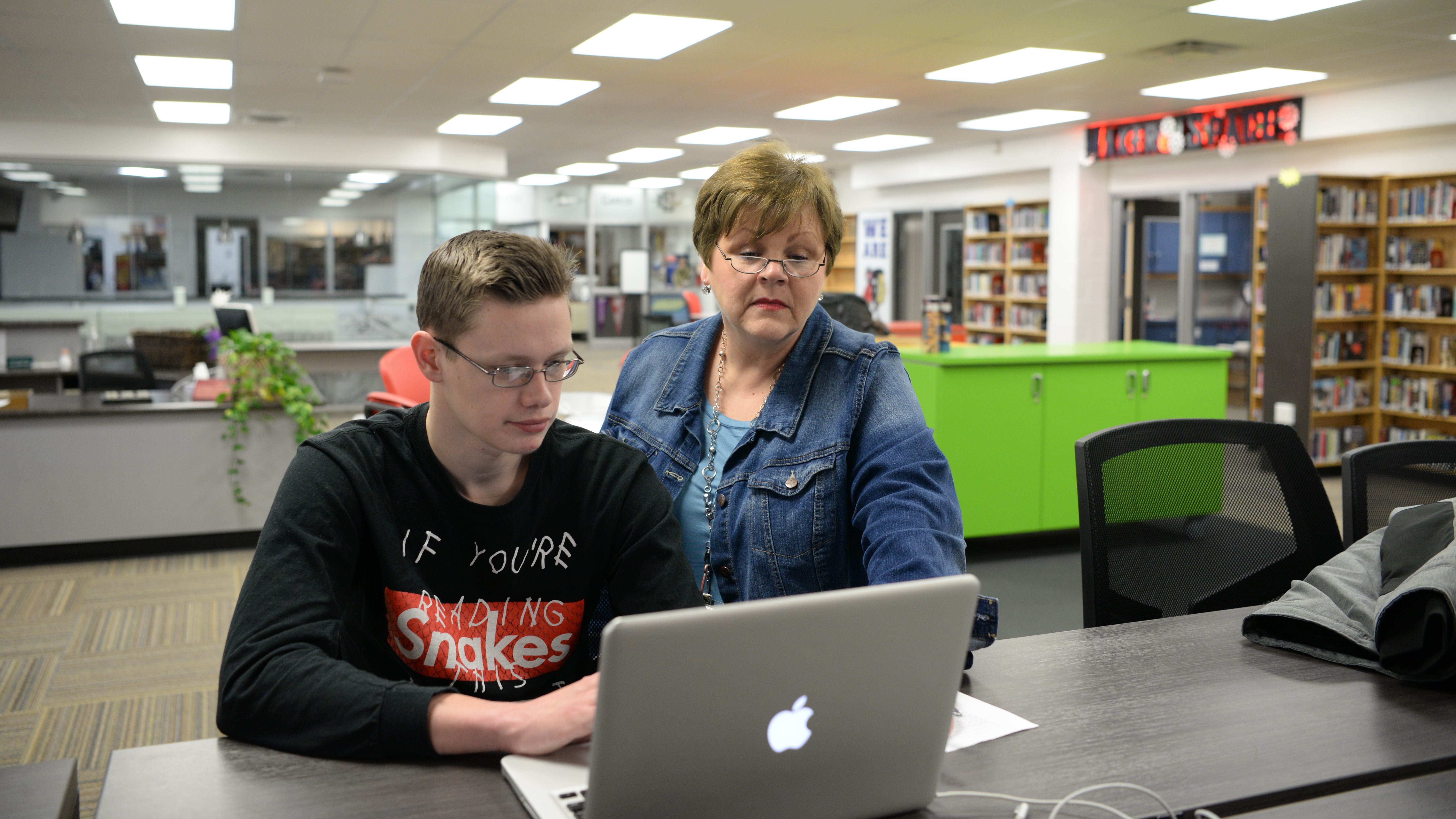 Sonja Wood, of South-Doyle High School, assists senior Cory Donathan as he fills out the FAFSA application. 