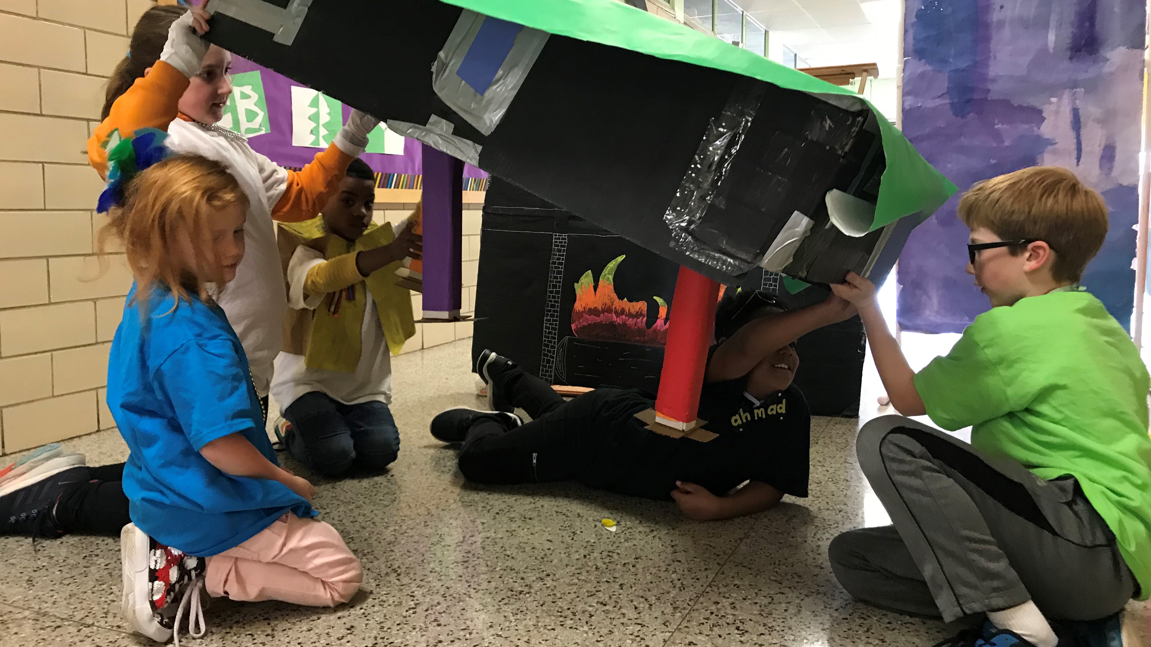 Green Magnet Academy students Birdie Lane (foreground) and (L-R) Sloan Frix, John Whittington, Ahmad Mack and Dansten Nichols, work on their Destination Imagination project, based on the board game 