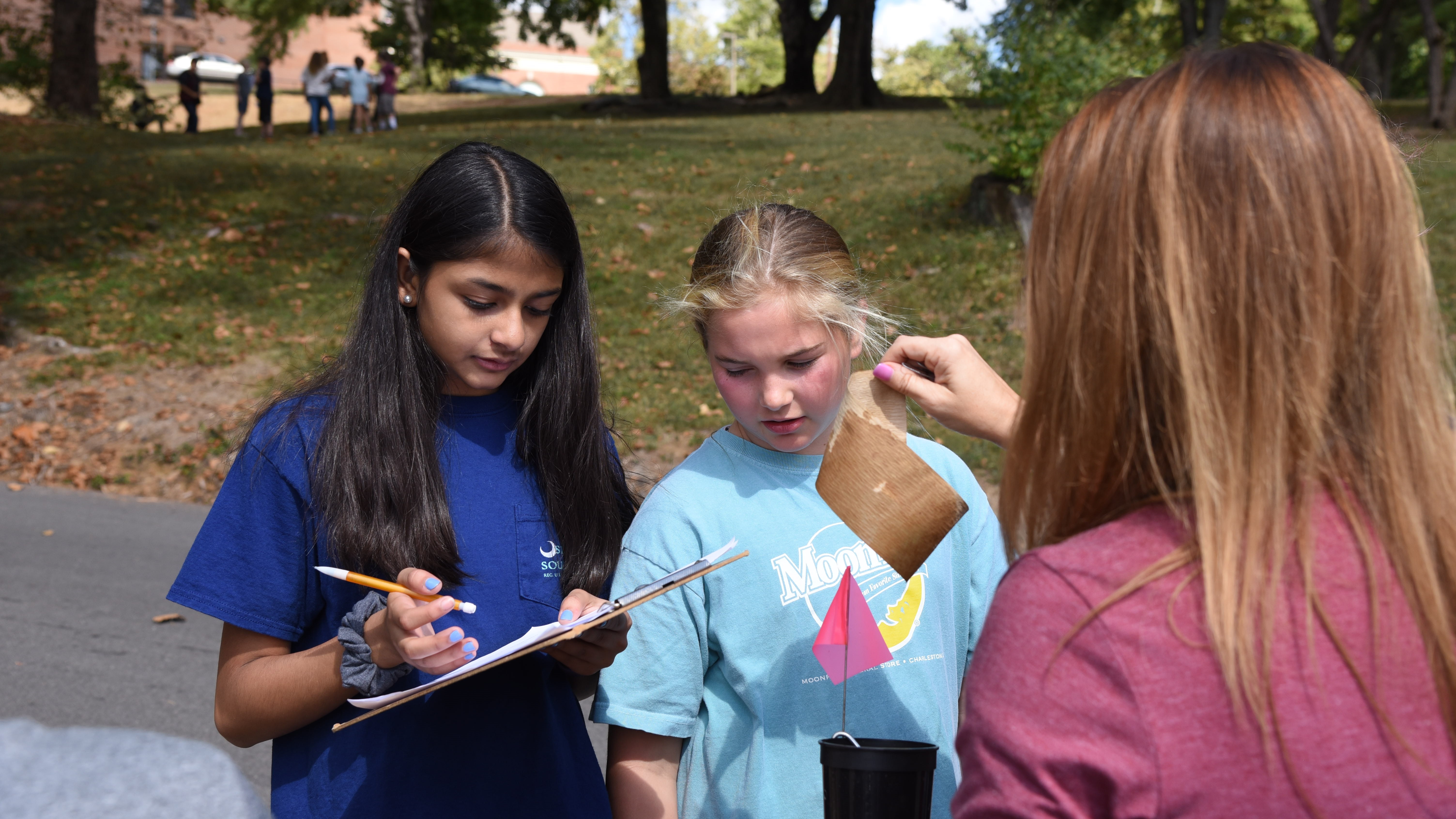 6th-graders Hetvi Patel, left, and Sophia Smelcer record data while Gresham Middle School teacher Nicole Resmondo examines seed germination paper. Students at Gresham are participating in a research study led by the University of Tennessee Institute of Agriculture that aims to promote science careers and to increase understanding of how La Crosse encephalitis is transmitted by mosquitos. 