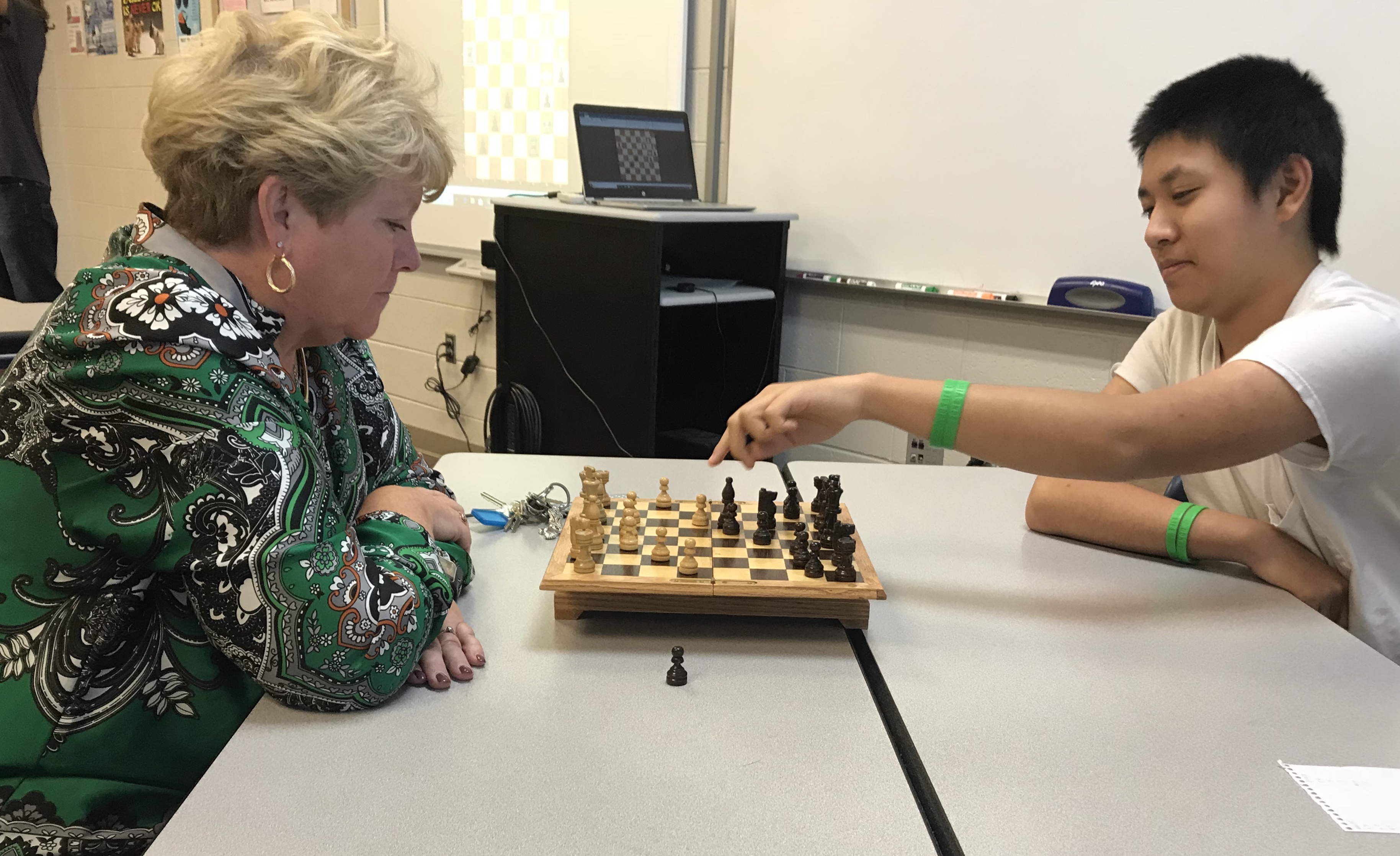 Hardin Valley Academy Principal Sallee Reynolds faces off against HVA sophomore Eric Zhao, during a match at the school's Chess Club meeting. 
