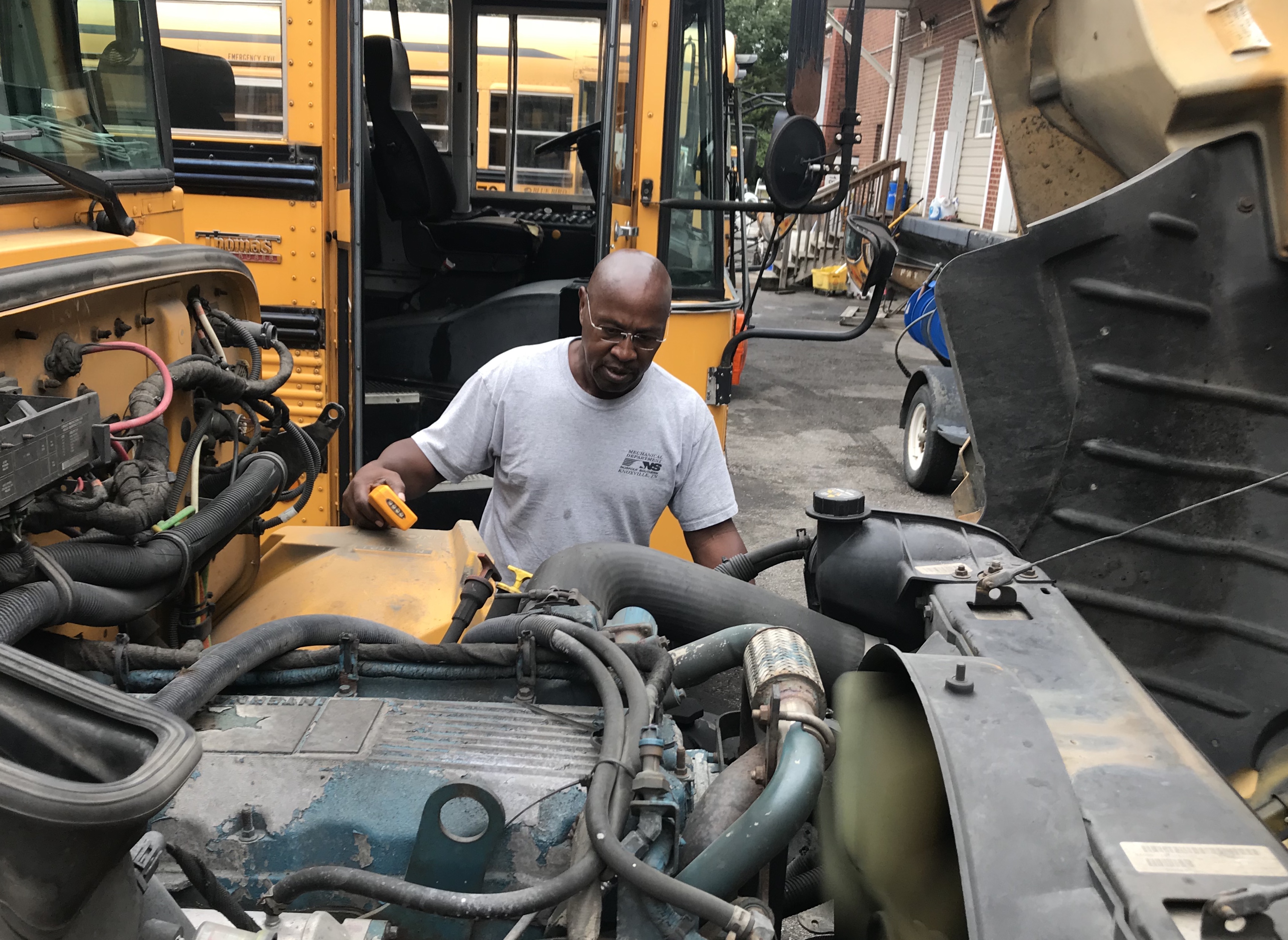 Lynch Bus Lines driver Terry Holloway checks under the hood as part of a standard pre-ride inspection of his school bus. 