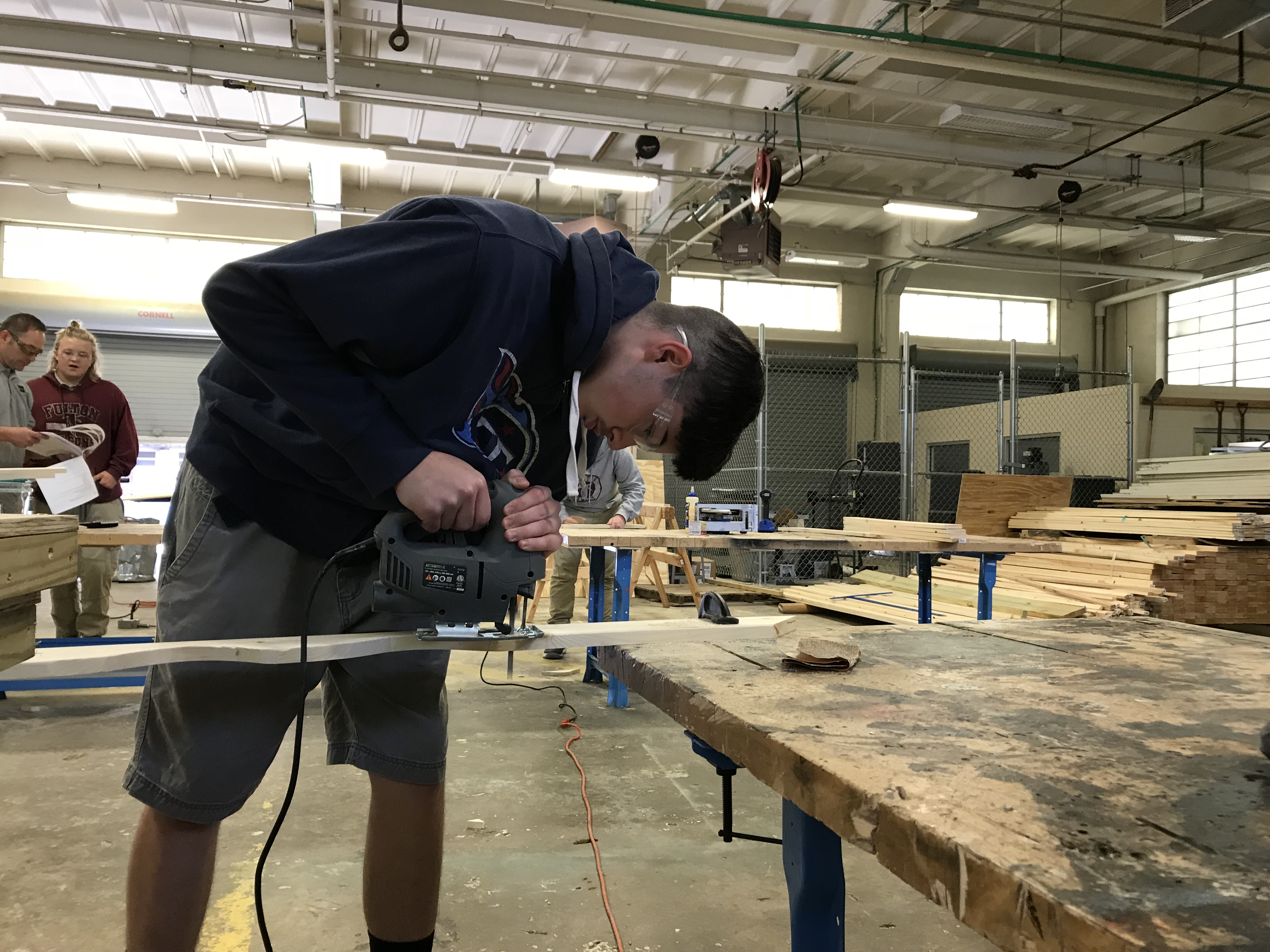 Fulton High School senior Matthew Maitland works on a fascia board for a playhouse sponsored by Habitat For Humanity. 