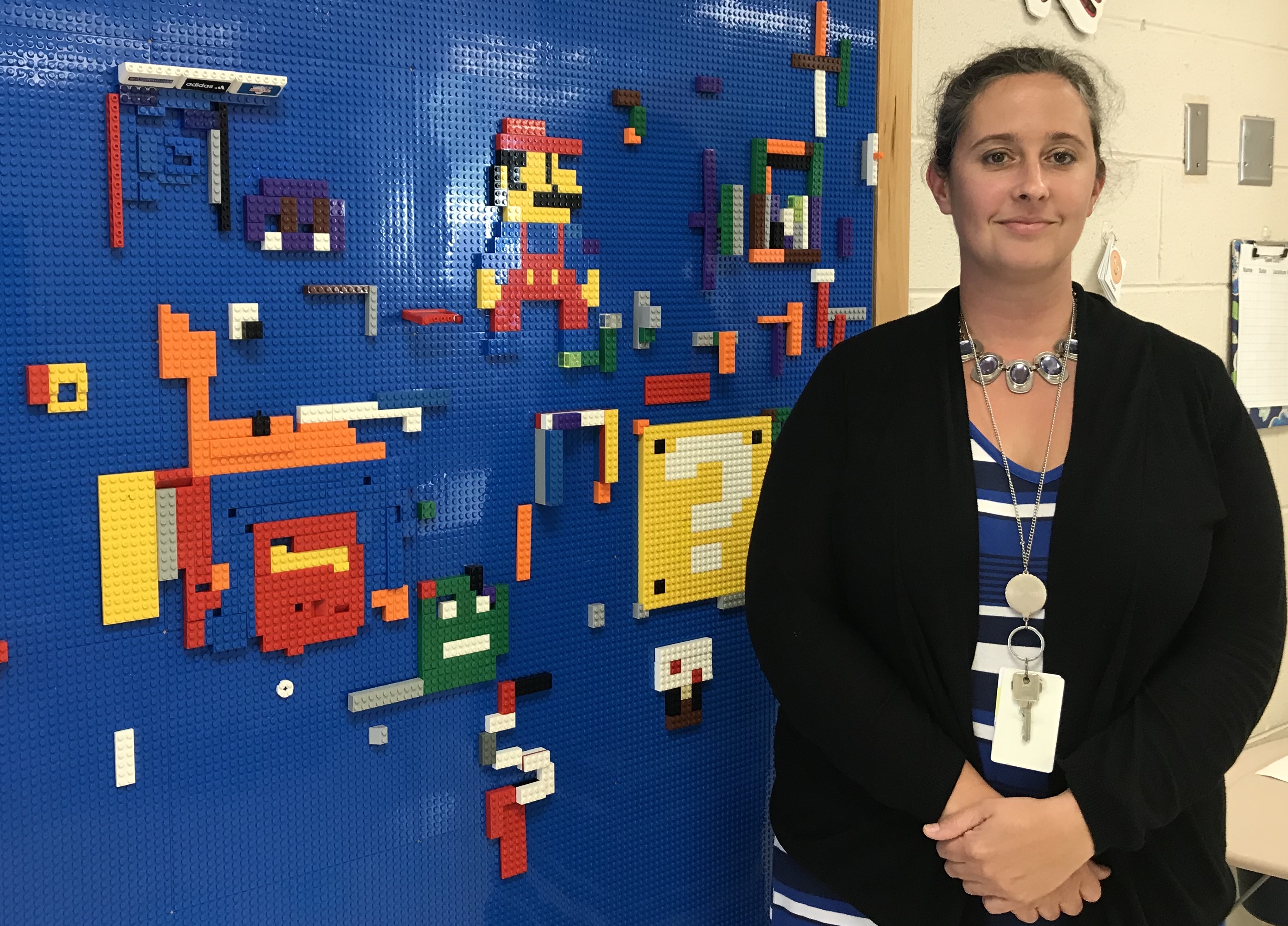 K-5 STEM educator Amanda Callahan-Mims stands in front of a Lego board at Spring Hill Elementary School.