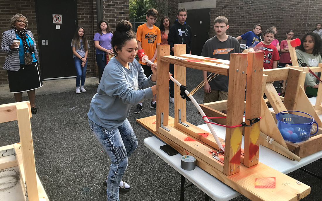 Nicole Garrett, an 8th grader at South-Doyle Middle School, prepares to launch a catapult that took her two days to build. 