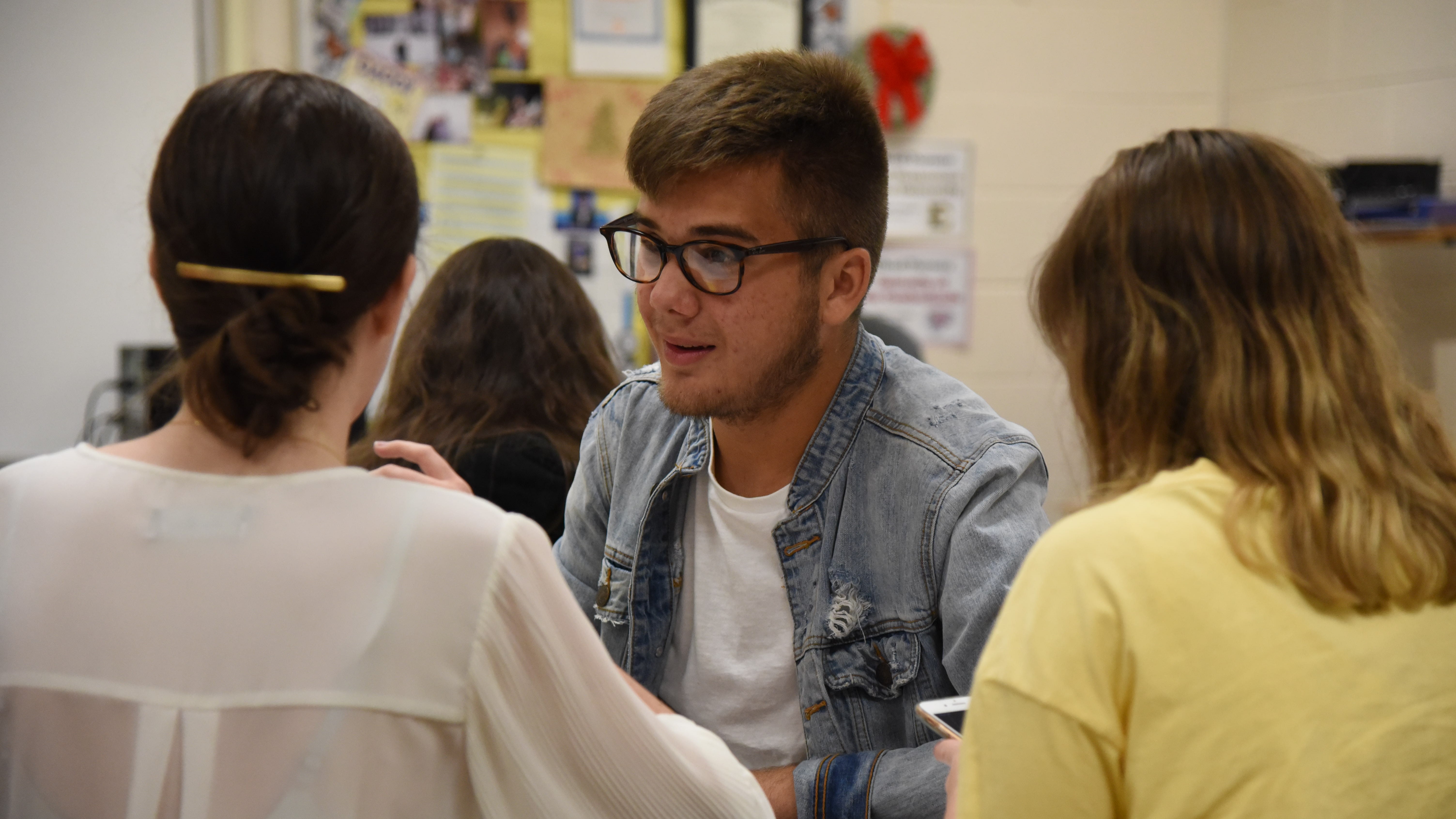 Karns High School senior Noah Kelley, who serves as the Student Representative on the Board of Education, discusses a project with classmates on August 28, 2019. 