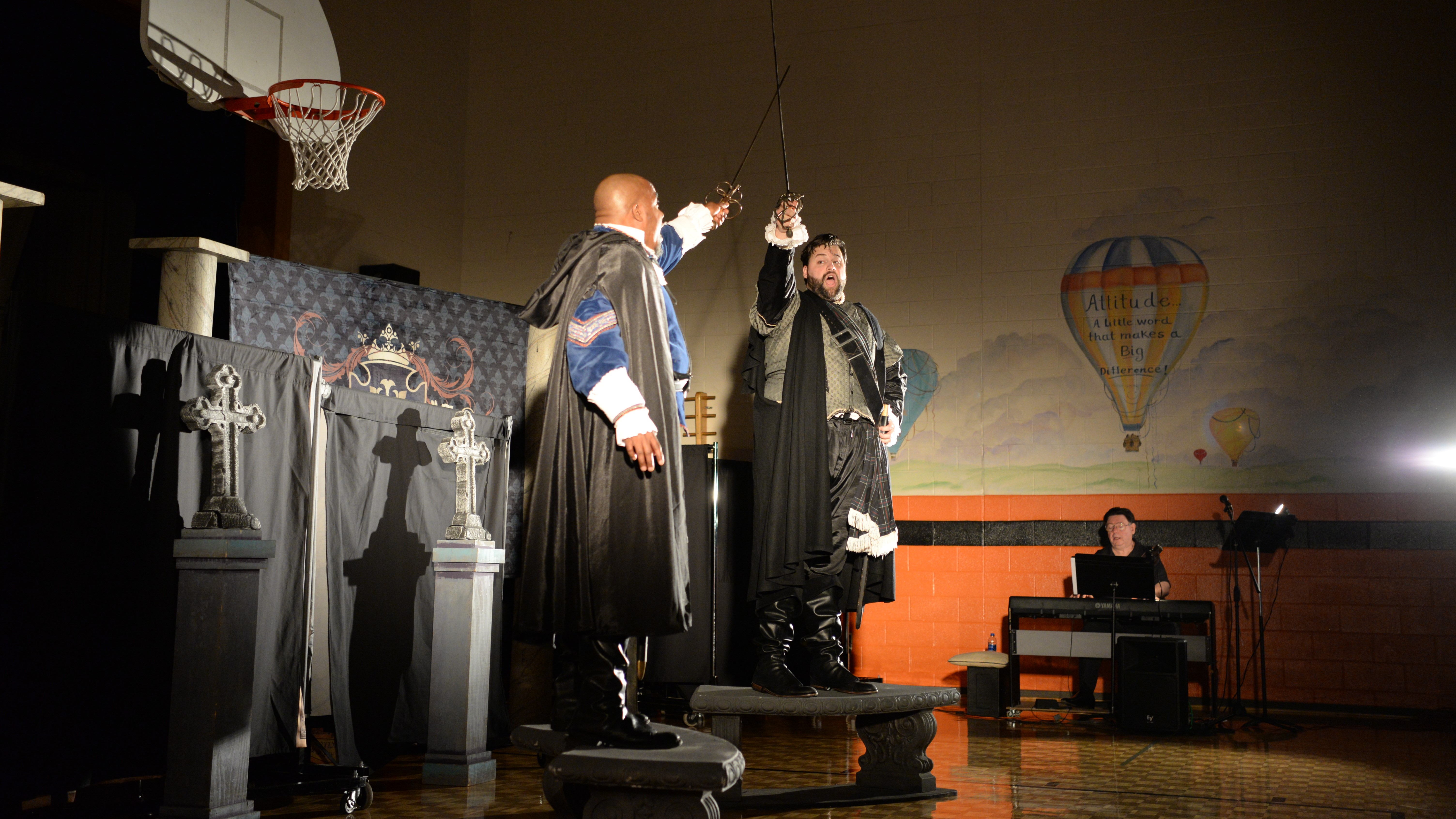 Baritone Eric McKeever (left) crosses swords with tenor Brandon Russell, during a Knoxville Opera performance at Powell Elementary School. 