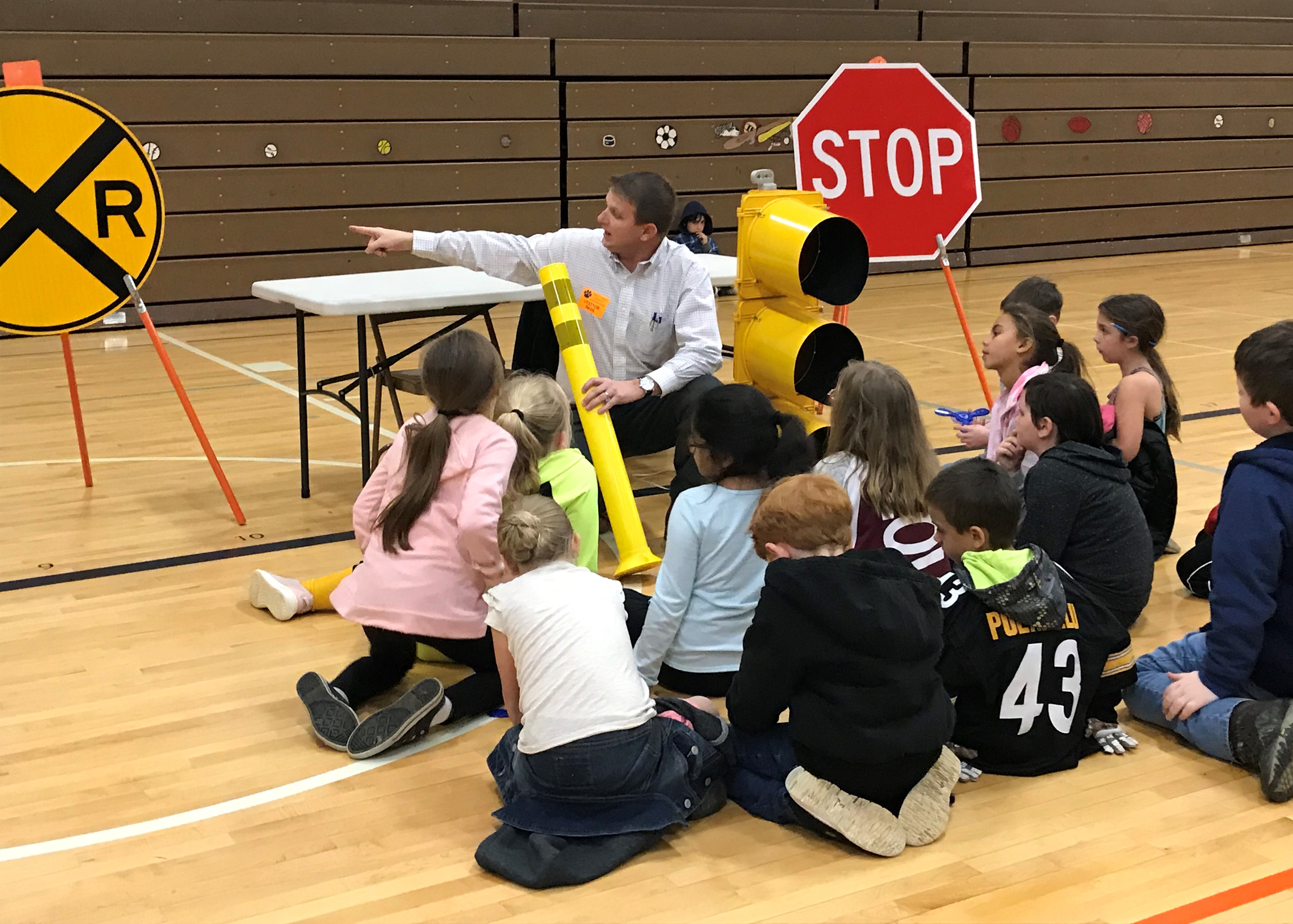 A student at East Knox County Elementary School uses a toy scope to watch as a National Guard helicopter lands at the school for Career Day. 