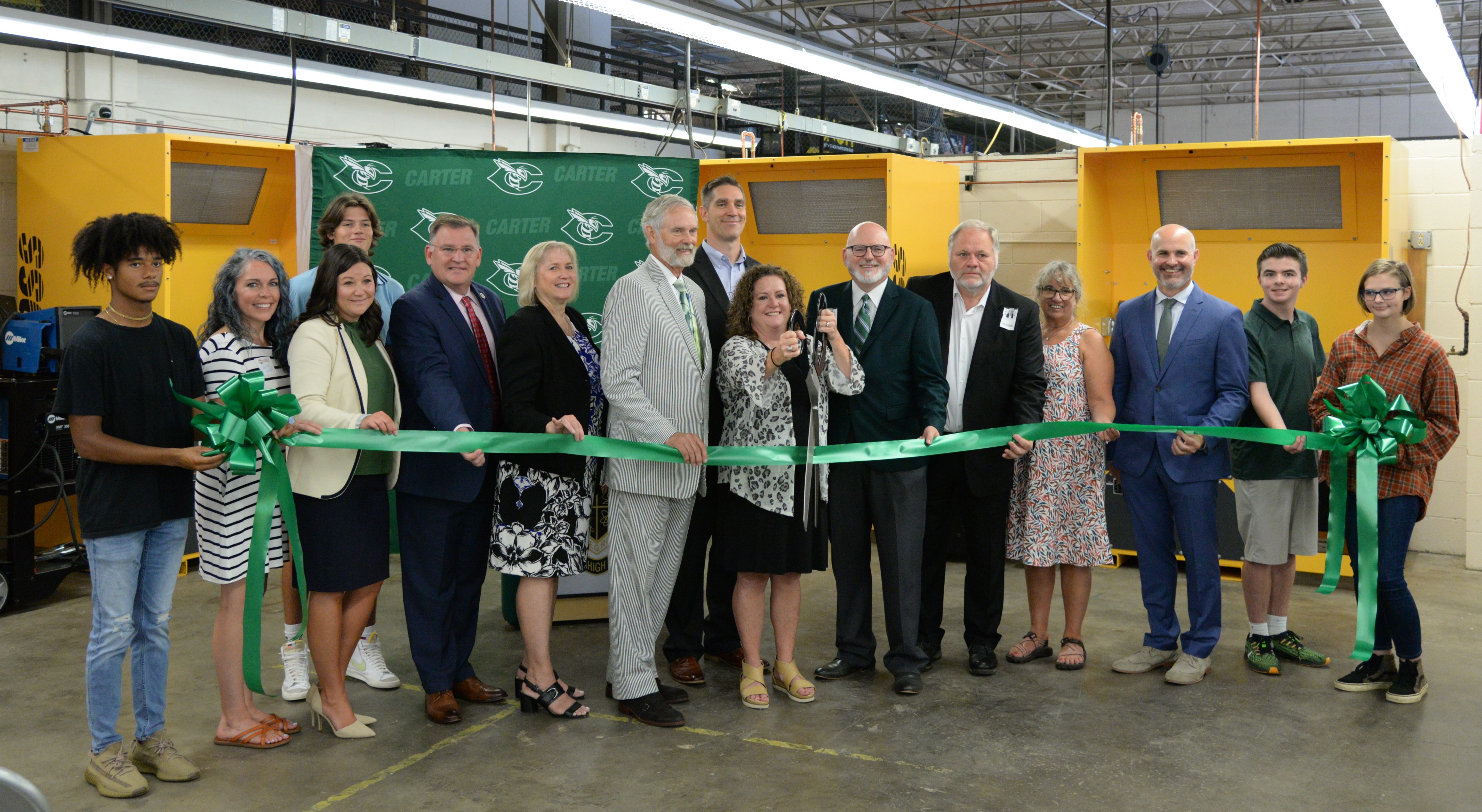 Carter High School principal Angie Messer, CHS students, district and community leaders cut the ribbon on a new welding lab at the school on Thursday, Aug. 26, 2021.