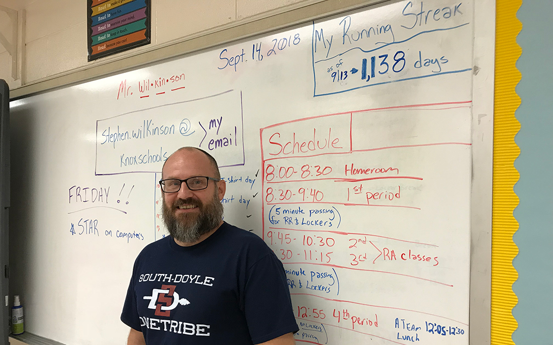 South-Doyle Middle School teacher Stephen Wilkinson stands in front of a markerboard showing his running streak on September 14, 2018. 