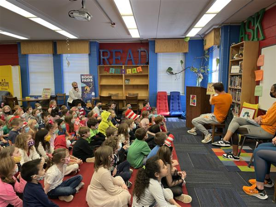 A group of children sit quietly as a story is read to him 